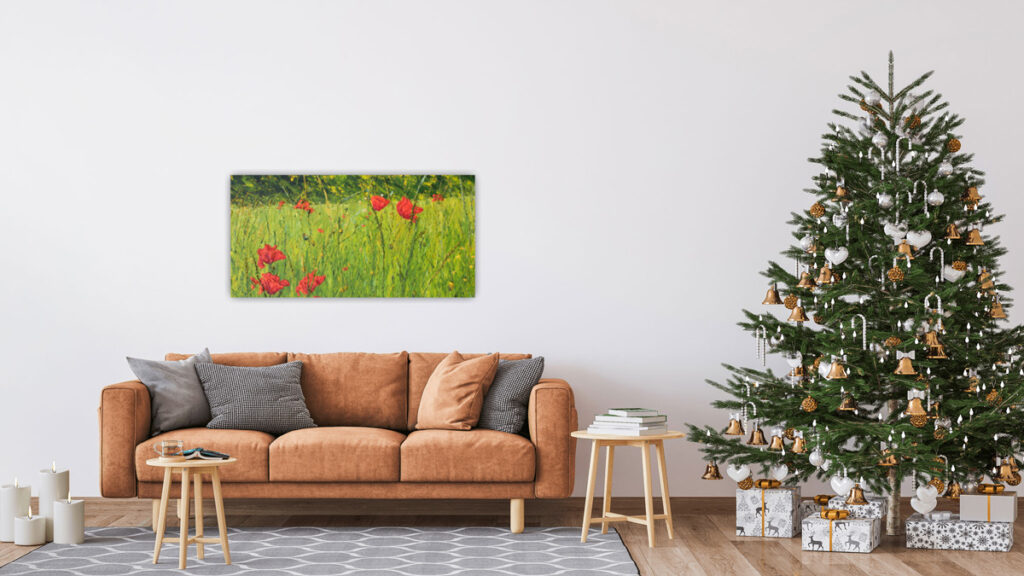 Room set with orange sofa, Christmas tree and wide painting above sofa - the painting shows a meadow scene with a few large poppy forms among varied greens and yellows